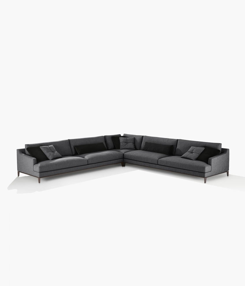 Bellport sofa with low armrest, removable cover in fabric Kushiro 07 ferro, cushions and lower back cushion in velvet Persia 1404 carbone, cushions with decoration in fabric Kushiro 07 ferro and feet with profile in mat champagne.