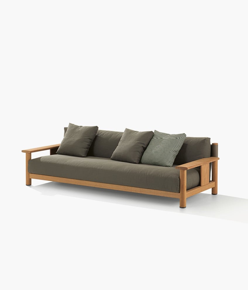 Ketch sofa with structure in solid natural iroko and backrest in EVA oliva, removable cover in fabric Merak 106 bosco with decorative drawstring stitching, cushions in fabric Merak 106 bosco and Zephiros 01 bosco.