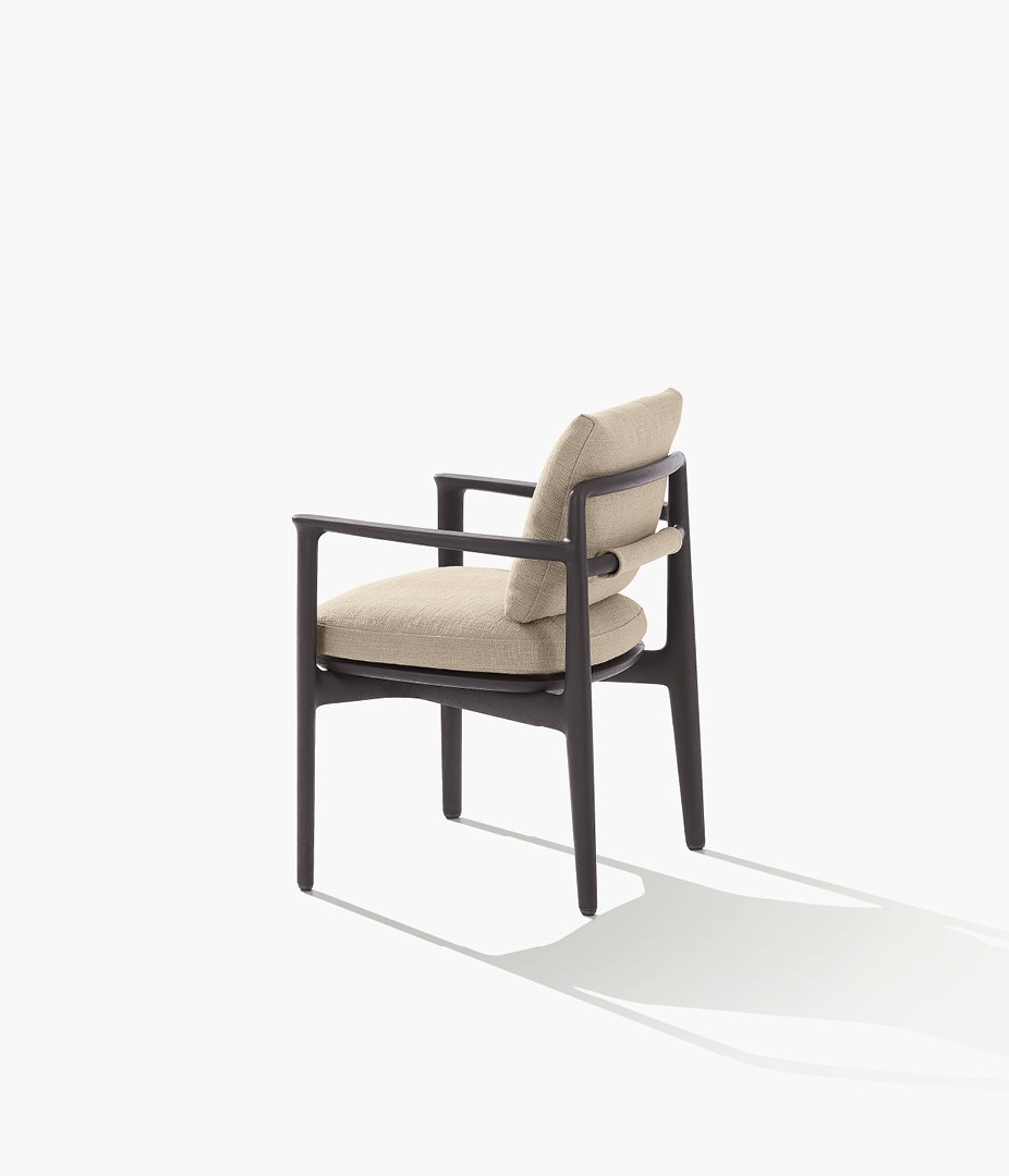 Magnolia chair, structure in solid black stained iroko, removable cover in fabric Karif 03 sabbia. Carpet Kamir mattone.