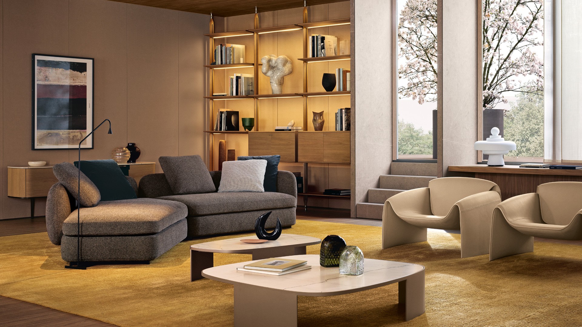 Диван Saint-Germain выполнен в обивке из ткани Agadir оттенка пепе и оснащён съёмным чехлом; декоративные подушки сочетают текстиль Nancy с эффектом ясеня и глубокий тёмно-серый бархат Persia. Опоры изготовлены из никеля с матовой коричневой отделкой. Журнальные столики Koishi дополнены столешницами из полированного мрамора Zecevo, а их каркасы окрашены в изысканный матовый тон шампанского. Кресла Le Club обтянуты кремовой шёлковой кожей с несъёмной обивкой. Книжный шкаф Lexington спроектирован с потолочными стойками из золотого дуба и элементов в матовом шампанском оттенке, регулируемые ножки выполнены из никеля цвета шампанского. Полки из золотого дуба и матового шампанского интегрируют скрытую светодиодную подсветку. Контейнерные модули с откидными и распашными фасадами сочетают золотой дуб и матовое шампанское, дополнены ручками из никеля цвета шампанского и встроенным LED-освещением. Бузери Surface оформлены льняной тканью цвета экрю и профилями в матовом оттенке шампанского.