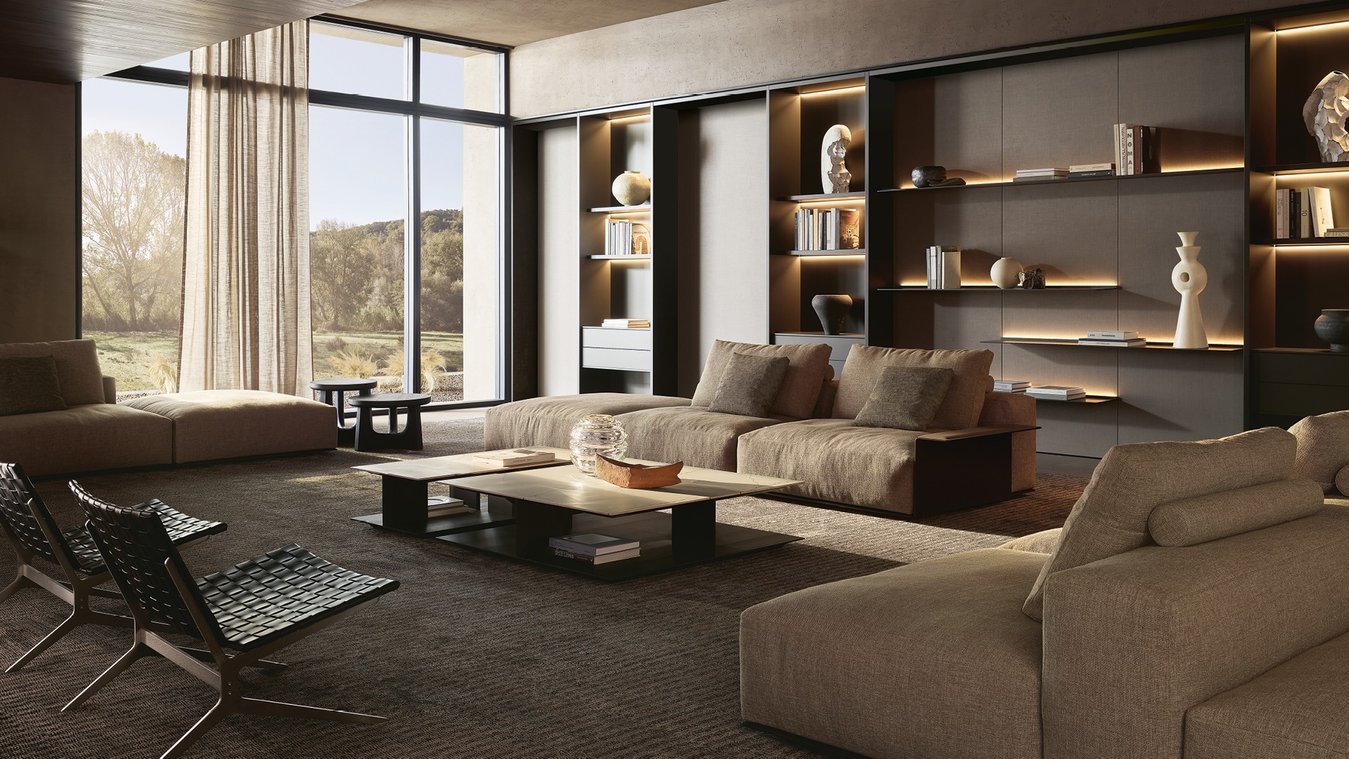 Диван Westside Soft со съемным чехлом из ткани Fushui 01 bronzo и подушками из ткани Janaky 02 champagne. Подлокотник Slim из кожи 08 fango; основание с матовой никелированной отделкой темного цвета. Кресло и пуф Kay Lounge, несъемный чехол из плетеной кожи черного цвета (02), структура с никелированной матовой отделкой Brown Nickel. Прямоугольные журнальные столики Westside со столешницей из шлифованного мрамора Зечево и структурой из черного вяза. Журнальные столики Nara со столешницей и структурой из окрашенного массива черного вяза. Декоративные панели из ткани lino grigio с профилями с матовой отделкой цвета ardesia. Полки Code с лакированной металлической отделкой цвета bronzo и задней подсветкой. Композиция Wall System: структура, полки и ящики Flat с лакированной отделкой цвета bronzo и встроенной светодиодной подсветкой; задние стенки с лакированной металлической отделкой цвета bronzo. Ковер Shindo grey.