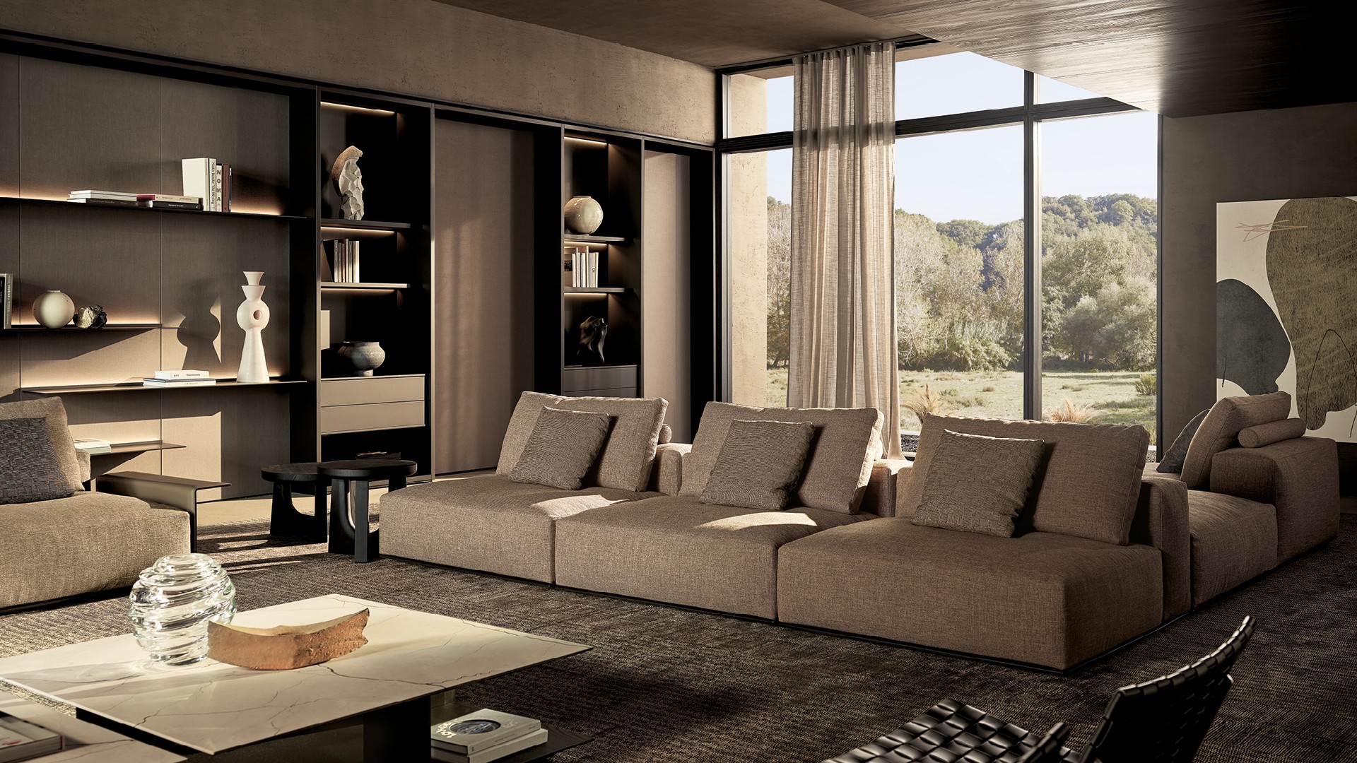 Divano Westside Soft con rivestimento sfoderabile tessuto Fushui 01 bronzo, cuscini in tessuto Janaky 02 champagne. Bracciolo Slim in cuoio 08 fango e bsament in brown nickel opaco. Poltrone Kay Lounge, rivestimento non sfoderabile in cuoio intrecciato 02 nero, struttura in brown nickel opaco. Tavolini Westside rettangolari con piano superiore in marmo zecevo levigato e struttura in olmo nero. Tavolini Nara, piano e struttura in legno massello tinto olmo nero. Boiserie Surface in lino grigio con profili ardesia opaco. Mensole Code retroilluminate in laccato metallico bronzo. Composizione Wall System con struttura, ripiani e cassetti Flat laccato bronzo con luce a led integrata, schienali in laccato metallico bronzo. Tappeto Shindo grey.