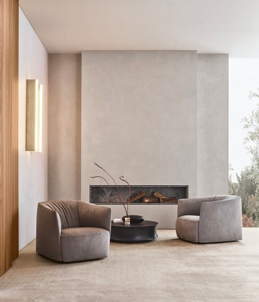 Santa Monica armchairs removable cover in leather Nabuk 02 tortora and normal double stitching. Soori coffee table in metalwith antique bronze finish.